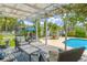 Inviting patio area featuring comfortable seating, offering a perfect spot for outdoor relaxation by the pool at 1807 Split Fork Dr, Oldsmar, FL 34677