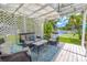 Relaxing pergola with comfortable seating overlooking the yard and beautiful lake at 1807 Split Fork Dr, Oldsmar, FL 34677