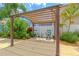Outdoor pergola featuring a charming seating area, perfect for enjoying the serene backyard at 1807 Split Fork Dr, Oldsmar, FL 34677