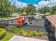 A playground with a slide and a see saw is surrounded by a black fence with greenery nearby at 1807 Split Fork Dr, Oldsmar, FL 34677