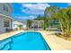 Inviting pool with a cozy pergola, lounge chairs, and lush landscaping, perfect for relaxation at 1807 Split Fork Dr, Oldsmar, FL 34677