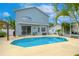 Inviting backyard oasis featuring a sparkling pool, lounge area, and lush landscaping at 1807 Split Fork Dr, Oldsmar, FL 34677