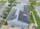 Aerial view of rooftop solar panels on home, surrounded by lush landscaping and well-manicured lawn at 1807 Split Fork Dr, Oldsmar, FL 34677