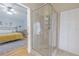 Shower featuring glass enclosure with views of the bedroom and large walk-in closet at 1807 Split Fork Dr, Oldsmar, FL 34677