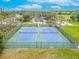 Aerial view of Sheffield Park showing two fenced tennis courts in a verdant setting at 1807 Split Fork Dr, Oldsmar, FL 34677