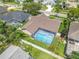 Aerial view of the home showcasing backyard pool and green landscaping in a quiet neighborhood at 1838 Eagle Ridge Blvd, Palm Harbor, FL 34685