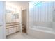 Bathroom with a soaking tub, glass shower, and dual vanities at 1838 Eagle Ridge Blvd, Palm Harbor, FL 34685