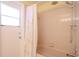 Bathroom featuring a shower with bathtub, neutral tile, and exterior access door at 1838 Eagle Ridge Blvd, Palm Harbor, FL 34685
