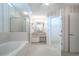 Bathroom featuring a soaking tub, glass shower, and double sink at 1838 Eagle Ridge Blvd, Palm Harbor, FL 34685