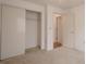 Carpeted bedroom features a closet and access to another room at 1838 Eagle Ridge Blvd, Palm Harbor, FL 34685