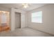 Bedroom with a ceiling fan, neutral carpet, closet, and window at 1838 Eagle Ridge Blvd, Palm Harbor, FL 34685
