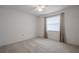 Bedroom featuring neutral walls, neutral carpet, and window with drapes at 1838 Eagle Ridge Blvd, Palm Harbor, FL 34685
