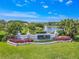 Beautiful community entrance with lush landscaping, water feature and a lake view at 1838 Eagle Ridge Blvd, Palm Harbor, FL 34685
