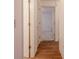 Bright hallway featuring hardwood flooring and white trim leading to a bedroom at 1838 Eagle Ridge Blvd, Palm Harbor, FL 34685