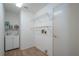 Bright laundry room featuring built-in shelving, cabinet, and a sink for added convenience at 1838 Eagle Ridge Blvd, Palm Harbor, FL 34685