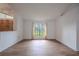 An empty living room with tile floors, bright white walls, and large windows at 1838 Eagle Ridge Blvd, Palm Harbor, FL 34685