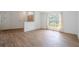 Bright, open living area with wood-look tile flooring and large windows at 1838 Eagle Ridge Blvd, Palm Harbor, FL 34685