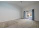 Spacious main bedroom with a large closet and sliding glass door to the pool area at 1838 Eagle Ridge Blvd, Palm Harbor, FL 34685