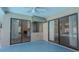 Enclosed patio with ceiling fans and built-in grill area and sliding doors leading indoors at 1838 Eagle Ridge Blvd, Palm Harbor, FL 34685