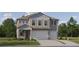 Charming two-story home featuring a three-car garage and beautifully landscaped front yard at 18460 Serene Lake Loop, Lutz, FL 33548