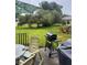 Lush backyard with mature trees, patio furniture, and a barbecue grill at 18804 Tournament Trl, Tampa, FL 33647