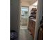 Hallway view of bathroom with skylight, vanity, toilet and a storage area with drawers and shelving at 18804 Tournament Trl, Tampa, FL 33647