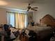 Cozy bedroom featuring a ceiling fan and a comfortable bed at 18804 Tournament Trl, Tampa, FL 33647