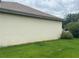 Side view of a home with lush landscaping and a well-maintained exterior at 18804 Tournament Trl, Tampa, FL 33647
