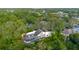 Aerial view of a private home surrounded by lush greenery and mature trees at 1974 Hidden Springs Pl, Clearwater, FL 33760