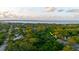 An aerial view of the property, showcasing its location amongst the trees at 1974 Hidden Springs Pl, Clearwater, FL 33760