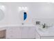 Bright bathroom with double sinks, soaking tub, and white cabinets at 1974 Hidden Springs Pl, Clearwater, FL 33760