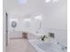 Spacious bathroom featuring a soaking tub, double sinks, and vanity area at 1974 Hidden Springs Pl, Clearwater, FL 33760