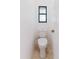 A small, well-lit bathroom features tile flooring and updated fixtures at 1974 Hidden Springs Pl, Clearwater, FL 33760