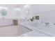 Spacious bathroom featuring a soaking tub, double sinks, and vanity area at 1974 Hidden Springs Pl, Clearwater, FL 33760