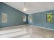 Spacious primary bedroom features tile floors, vaulted ceilings and natural light from multiple windows at 1974 Hidden Springs Pl, Clearwater, FL 33760