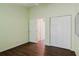 Well-lit bedroom featuring wood-look flooring and spacious closet at 1974 Hidden Springs Pl, Clearwater, FL 33760