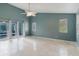 A bedroom with tile flooring, multiple windows, and a sliding glass door to the outside at 1974 Hidden Springs Pl, Clearwater, FL 33760