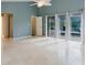 Bright, open bedroom featuring tile floors, patio access and view of the outdoor space at 1974 Hidden Springs Pl, Clearwater, FL 33760