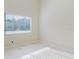 Bright bedroom featuring a window with natural light and neutral wall tones at 1974 Hidden Springs Pl, Clearwater, FL 33760