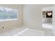 A bright bedroom leads to a living room with white marble floors and a view of the chandelier at 1974 Hidden Springs Pl, Clearwater, FL 33760