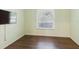 Inviting bedroom with wood-look flooring and a large window at 1974 Hidden Springs Pl, Clearwater, FL 33760