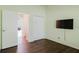 Clean bedroom includes wood-look floors and a closet at 1974 Hidden Springs Pl, Clearwater, FL 33760