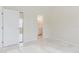 Neutral toned bedroom features a sliding closet door and open access to bathroom at 1974 Hidden Springs Pl, Clearwater, FL 33760