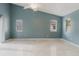 Bedroom featuring tile floors, three windows and neutral paint at 1974 Hidden Springs Pl, Clearwater, FL 33760