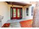 Inviting front entrance featuring a bright red double door and stylish hanging lanterns at 1974 Hidden Springs Pl, Clearwater, FL 33760