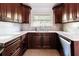 The kitchen features modern stainless steel appliances and dark wooden cabinetry at 1974 Hidden Springs Pl, Clearwater, FL 33760
