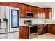Well-equipped kitchen features stainless steel appliances, wooden cabinetry, and a marble countertop at 1974 Hidden Springs Pl, Clearwater, FL 33760