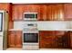 The kitchen features stainless steel appliances, wooden cabinets, and light countertops at 1974 Hidden Springs Pl, Clearwater, FL 33760