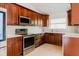 Kitchen featuring custom wood cabinets, stainless steel appliances, and light marble countertops at 1974 Hidden Springs Pl, Clearwater, FL 33760