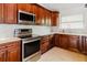 Gourmet kitchen with wood cabinets, stainless steel appliances, and marble countertops at 1974 Hidden Springs Pl, Clearwater, FL 33760